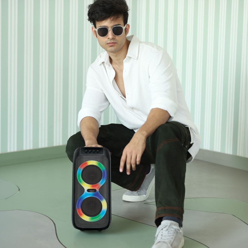 A male model posing with FINGERS Swag5 compact portable speaker